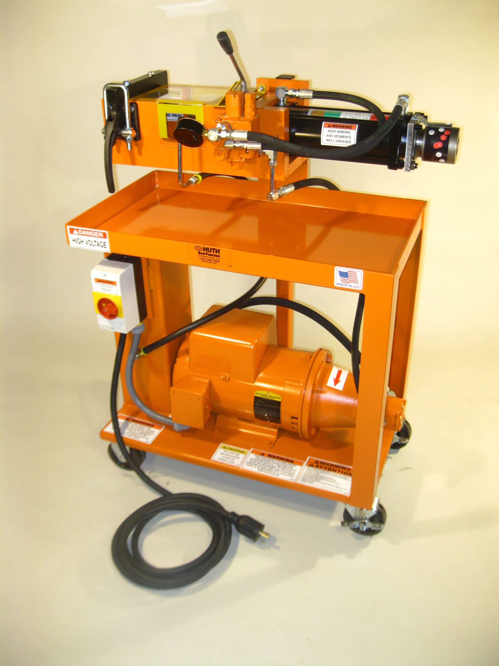 The 1673 Expander/Reducer is mounted on an orange cart with wheels for easy transport and movement. The expander/reducer is mounted on the top shelf of the cart, with tubing that connects to compressor tanks on the lower level.