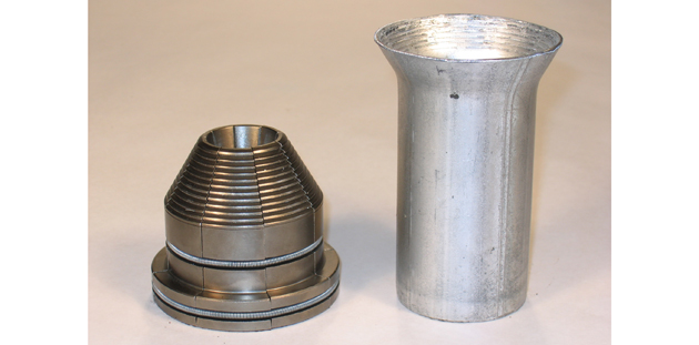 Two pieces of a Ben Pearson Segmented 45° Flare are cylindrical shaped with threaded interiors.