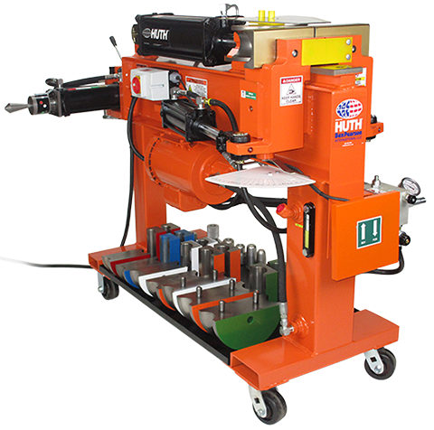 The orange HB-10 pipe bending machine is bright orange, with black controls and accessories. Beneath the machine, there is storage for the 028 die package and easy-to-move casters.