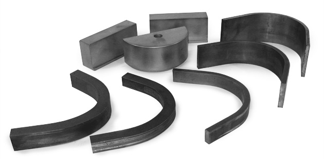 A set of eight flat stock bending dies are displayed together. The crescent-shaped dies help Huth pipe and tube benders shape flat tubes and pipes.