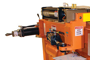 A Huth HB 10 pipe and tube bending machine is shown against a white background. The machine is orange with dark steel-colored tooling and control features.