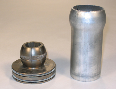 Two ball joint segments—the ball and joint are shown. One piece is short with a rounded, circular piece on top. The other part is tube-shaped, with an open, rounded end to hold the ball, creating a joint.