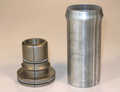 Two machine tooling components are shown against a white background. One is shorter and shaped like a bolt, with a large, flat end and a cylindrical shaft. The other silver-colored piece is a cylindrical tube.